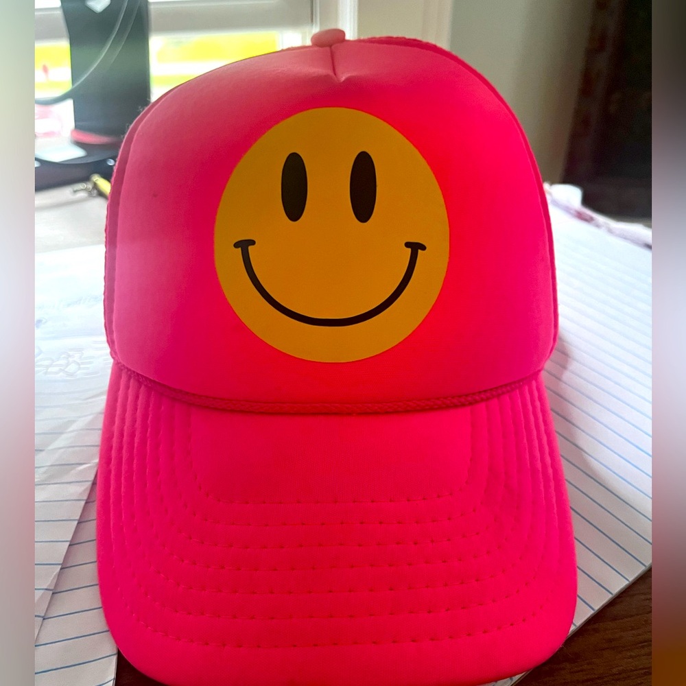 Pink hat with yellow smiley face